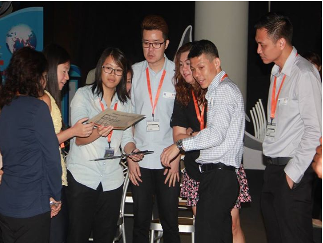 Employees engaging in an outdoor problem-solving task
