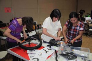 Participants deepening their bonds while building bikes for charity