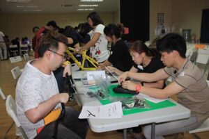 Participants strengthening teamwork while building bikes for charity