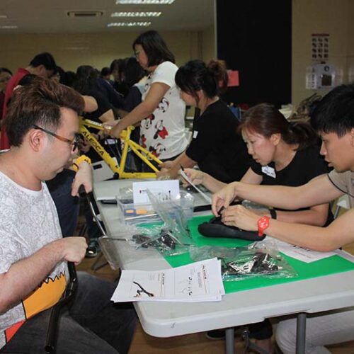 Participants strengthening teamwork while building bikes for charity